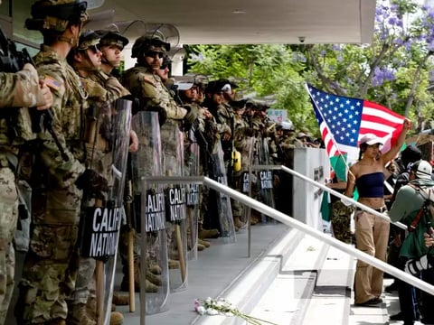 Protesters stand off against California National Guard soldiers at the Federal Building in downtown Los Angeles during a "No Kings" protest on Saturday.