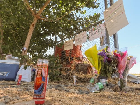 Candles, flowers and signs demanding answers from local officials Monday, July 7, 2025, in Esparto near the site of the fireworks warehouse explosion that killed seven.