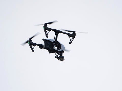 In this Thursday, Aug. 8, 2019, file photo, a drone flies in a residential neighborhood in Upper Moreland, Pa.
