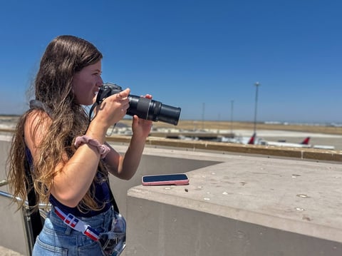 Marissa Forte tracks a departing jet at Sacramento International Airport on July 18, 2025. Forte said she will sometimes spend hours spotting and photographing planes.