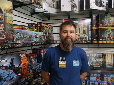 Dylan Anderson stands in front of a LEGO display Friday, July 25 ahead of their grand opening on Saturday.