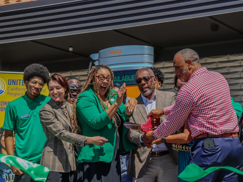 Organizers and students cut the ribbon to celebrate the launch of a new EV charging hub at South Sacramento Christian Center on Aug. 5.