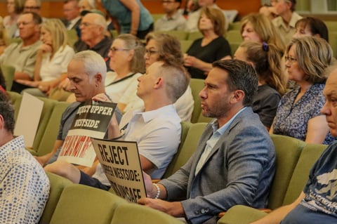 Residents opposing the Upper Westside development sit ready to protest the project on August 12, 2025.