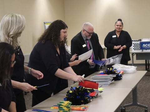 SchoolsFirst Federal Credit Union members stuff backpacks full of supplies during the backpack challenge on Wednesday at the Sacramento County of Education.