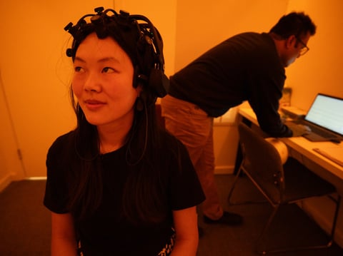Veronica Then from the California Lighting Technology Center sits in the amber light of UC Davis's Color Lab during a stress-relieving experiment.