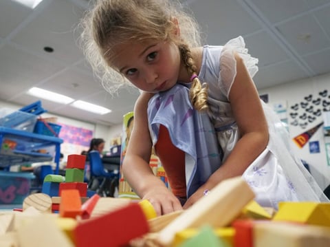 A transitional kindergarten student at Castro Valley Unified’s Independent Elementary School stacks blocks during activity time.
