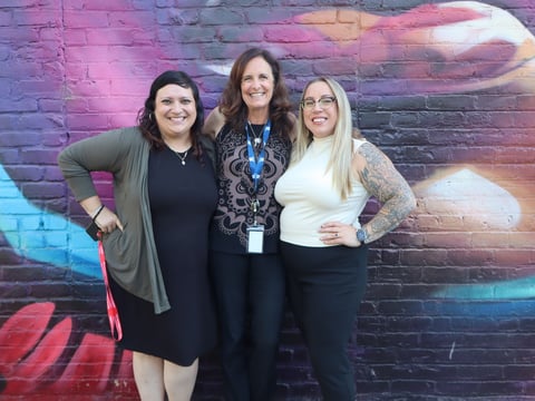 (L-R) Sarah Handee, Ashlie Bryant, and Kristi Merrill stand outside of The Table building in downtown Monday, August 25, 2025.
