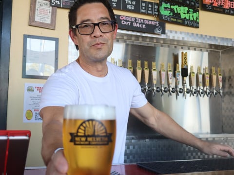 David Gull, the owner of New Helvetia Brewing Company, serves up a pint of beer for his general manager on Friday, September 12.