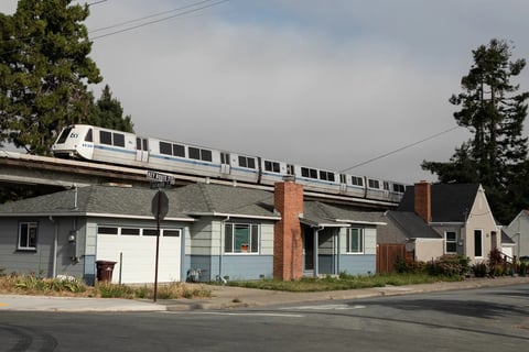 A BART train runs above single-family homes in Albany on July 22, 2019. Photo by Anne Wernikoff, CalMatters
