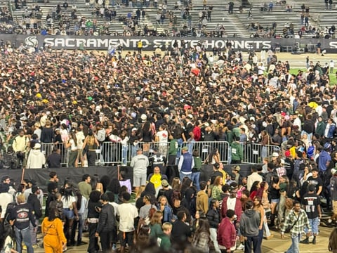 Attendees gather on the field to see the post-game concert from rapper Lil Yachty.