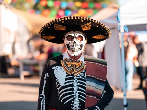 One participant at the El Panteon de Sacramento celebration in 2024 with skull face painting for Dia de Muertos.