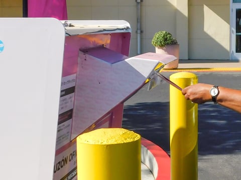 A driver drops off their ballot at the drive-through ballot drop box in the Elections Office parking lot at 7000 65th Street, Sacramento, Thursday, Oct. 23, 2025.