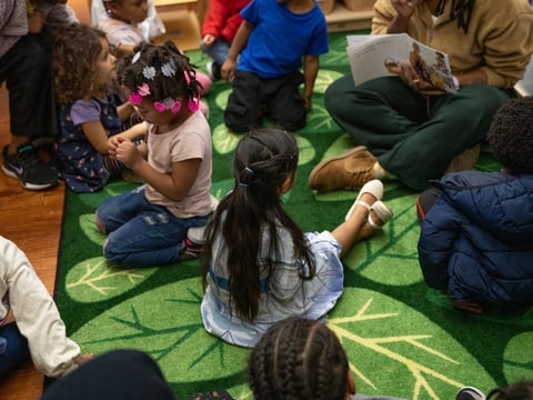 Children listen during storytime at the Ralph Hawley Head Start Center at the YMCA of the East Bay in Emeryville on Dec. 9, 2024.