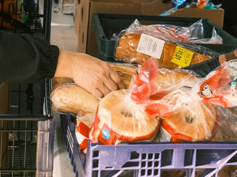 A shopper picks out bagels at River City Food Bank. Oct. 30, 2025