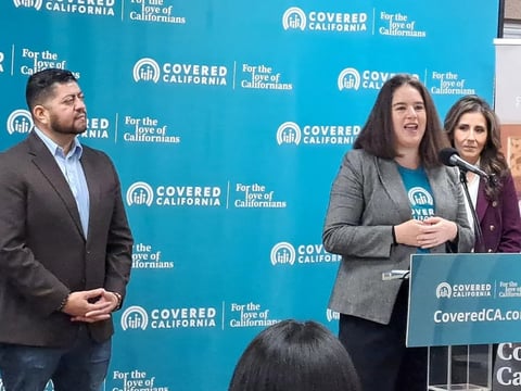 Covered CA Executive Director Jessica Altman addresses reporters at an event in Fresno on Nov. 13, 2025. Joining her are District 3 Supervisor Luis Chavez, left, and Dr. Olga Meave, CEO of Clinica Sierra Vista health clinics. (Photo Tim Sheehan)
