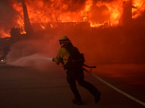 A firefighter battles flames from the Palisades Fire in the Pacific Palisades neighborhood of Los Angeles on Jan. 7, 2025.