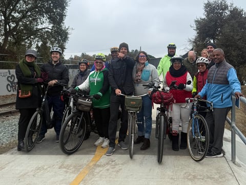 Pedestrians and council members celebrate the reopening of the Del Rio Trail Bridge.
