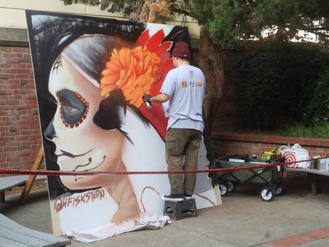 Local artist painting live at the Tardeada festival at Sacramento City College.