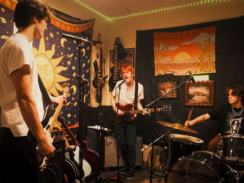 Members of the bands Carport and Tovidence play together at DNL Studios in Citrus Heights on Dec. 8 2025.