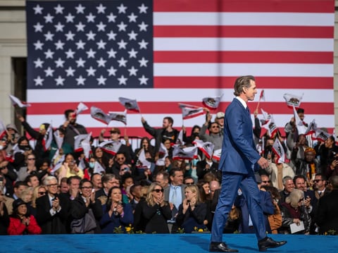 Gov. Gavin Newsom leaves the stage after addressing attendees at his inauguration for a second term at the Plaza de California in Sacramento on Jan. 6, 2023.