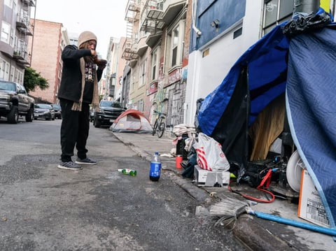 Linda Vazquez, 52, eats noodle soup outside of her tent on Cedar Street in San Francisco on Nov. 19, 2024. City workers tell Linda and other unhoused people to move on a regular basis during homeless sweeps and cleaning operations.