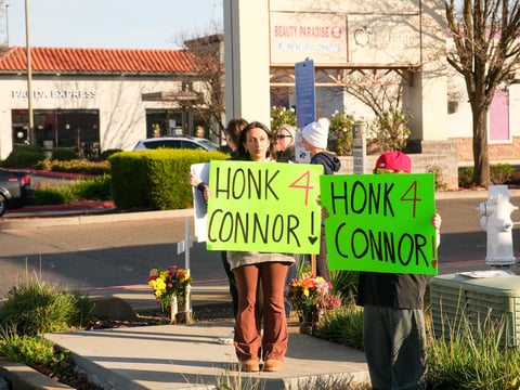 Ella Lopez stands with her family at the entrance to the Winco parking lot off Sheldon Road holding a sign to spread awareness about her brother Connor’s death on Wednesday, Jan. 28, 2026.