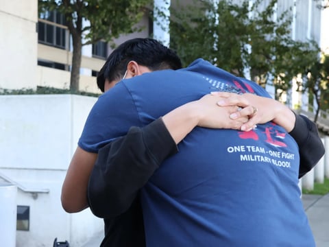 Julio Peña Jr. hugs his stepmother, Lydia Romero, outside an immigration detention facility in downtown Los Angeles as they try to get information about his father, Julio Cesar Peña, who was detained by ICE in December.