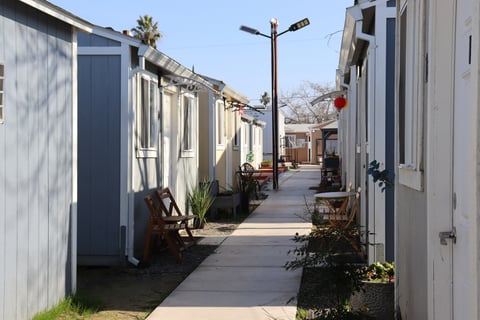 Cabins line a walkway at The Grove, a 50-cabin transitional housing site for people ages 18 to 24, on Tuesday, Feb. 3, 2026, in North Sacramento.