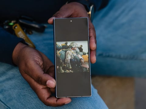 Laylah Rivers shows a photo on her phone from a 2016 training mission in Italy during her time as a paratrooper in the U.S. Army, in Culver City on Jan. 29, 2026.