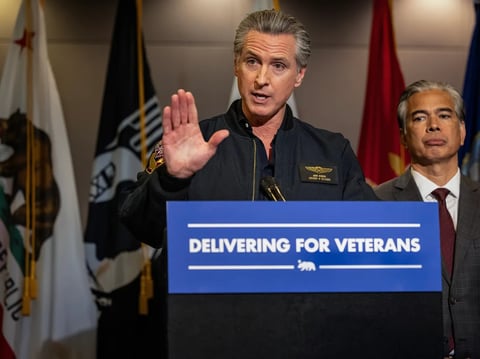 Gov. Gavin Newsom answers questions at the California Department of Veterans Affairs after signing a bill that prohibits unaccredited private companies from billing former military service members for help with their claims, on Feb. 10, 2026.