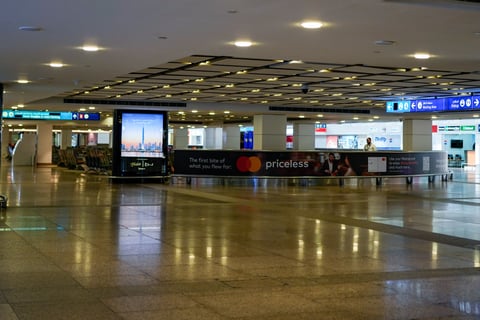 A worker is seen in the empty arrival hall at the Dubai International Airport terminal as the airport resumes limited operations in Dubai, United Arab Emirates, Thursday, March 5, 2026. (AP Photo/Altaf Qadri)