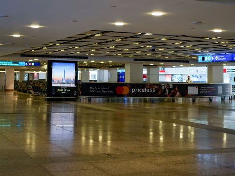 A worker is seen in the empty arrival hall at the Dubai International Airport terminal as the airport resumes limited operations in Dubai, United Arab Emirates, Thursday, March 5, 2026.