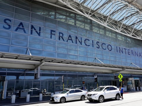 FILE - Vehicles wait outside the international terminal at San Francisco International Airport, in San Francisco, July 11, 2017.