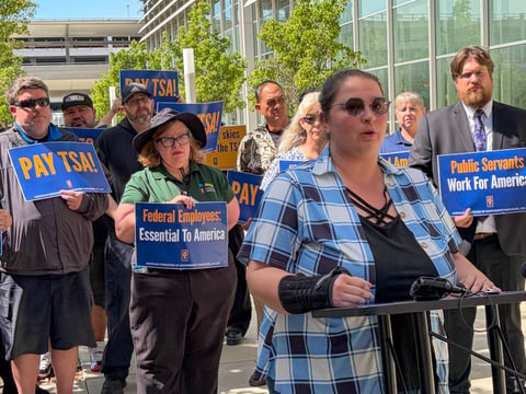 Kira Cushman, a TSA officer at Sacramento International Airport, addresses a rally outside Terminal B on Thursday, March 26, 2026. Cushman said she had to choose between rent and food after TSA agents stopped receiving pay.