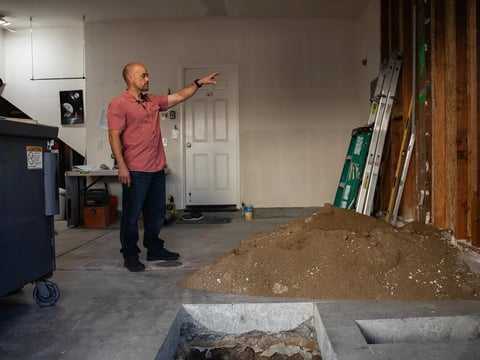 Adam Hardesty looks through the construction at his home in Carlsbad on Feb. 19, 2025. Hardesty wanted to convert the garage of his three-story condo into a ground-floor apartment despite opposition from his own Homeowners Association.