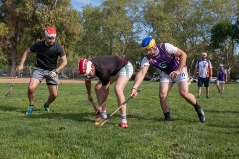 Matt Farrell (left), David Neligan (center) and Sean Anayah (right) battle for a sliotar during a practice game Saturday, March 21, 2026, in Sacramento.