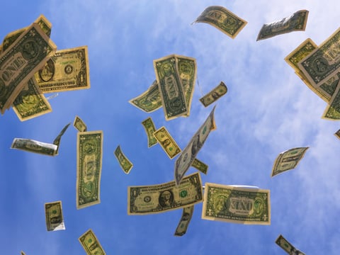 U.S. one-dollar bills are seen against the sky in Dallas, Tuesday, April 7, 2026.