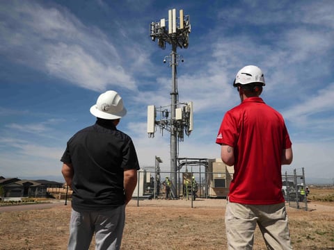 Workers observe a tower where Pano AI cameras are installed for detecting wildfires Monday, April 20, 2026, in Aurora, Colo.