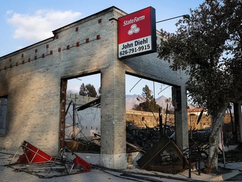 A sign remains above a State Farm insurance office, which burned in the Eaton Fire in Altadena, on Jan. 17, 2025.