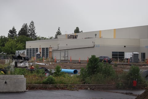 A fenced-off warehouse under construction at the Watt Avenue shelter site in North Highlands on May 4, 2026. The county purchased the property in 2022 for about $23 million.