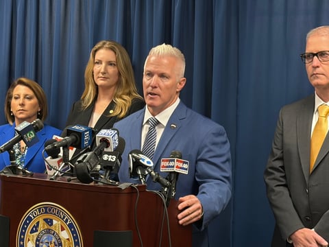 Yolo County District Attorney Jeff Reisig (second from right) speaks at a news conference Friday, April 10, 2026, in Woodland, Calif., announcing indictments connected to the deadly July 2025 Esparto explosion.