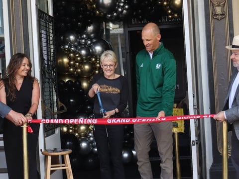 Owner of Evangeline's Costume Mansion Deborah Chaussé cuts the ribbon during the ceremony in Old Sacramento Friday, June 26, 2026. The shop will officially re-open to the public Saturday morning, after a fire last year forced the storefront to close.