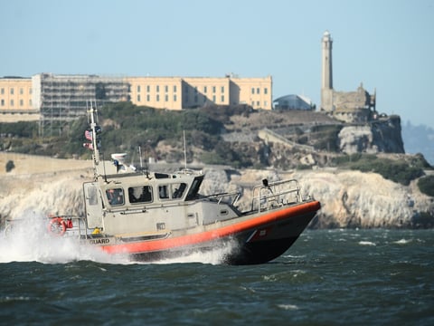 A U.S. Coast Guard crew goes past Alcatraz Island near the site of a pontoon boat accident on Tuesday, July 14, 2026, in San Francisco.