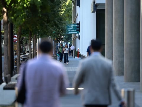 State workers and city residents walk through downtown Sacramento on the morning of July 15, 2026. Photo by Miguel Gutierrez Jr., CalMatters