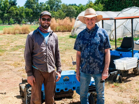 The Farm Manager at Soil Born Farms, Tom Lyons (Left) and Steve Heckeroth, CEO of Renewables, Inc. (Right) pose for a photo in front of an electric remote control tractor on the left and a solar-powered version the right on Friday, July 24, 2026.