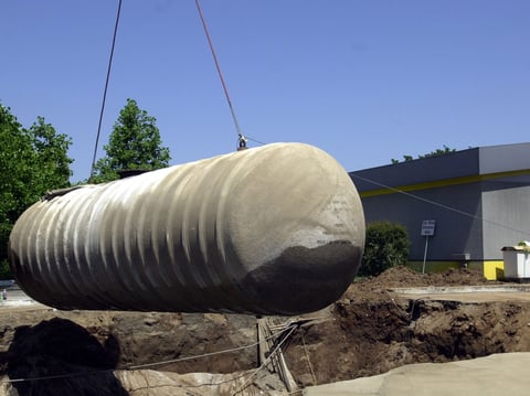 In this May 23, 2003 file photo, workers remove a 10,000-gallon underground gasoline storage tank to be replaced with a new tank at a gas station in Sacramento, Calif.