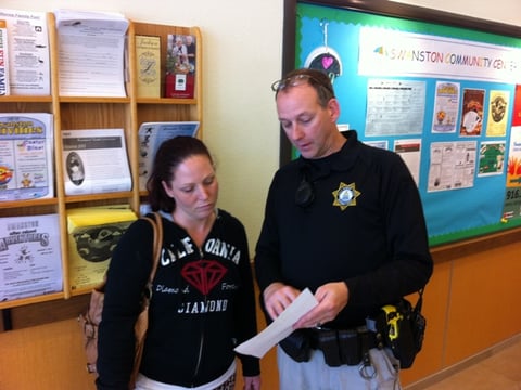 Parent Tina Moseley looks over paperwork with Sheriff's Deputy Michael Saigeon.  Moseley hopes the SHOCK program will help her family.