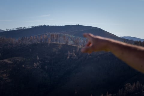 Dan Efseaff of the Paradise Recreation and Park District points to where the fire came over the ridge and into Paradise. Cal Fire determined that the fire started near the rural community of Pulga, east of Paradise.
