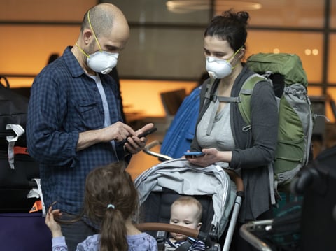 People arriving on a flight from Europe at Logan International Airport in Boston, ahead of a travel ban, on Friday, March, 13, 2020.