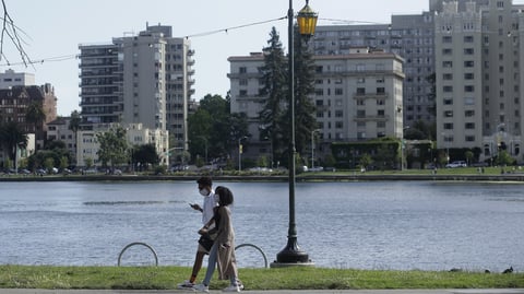 A couple walks around Lake Merritt in Oakland, where several nooses were found hanging from trees.